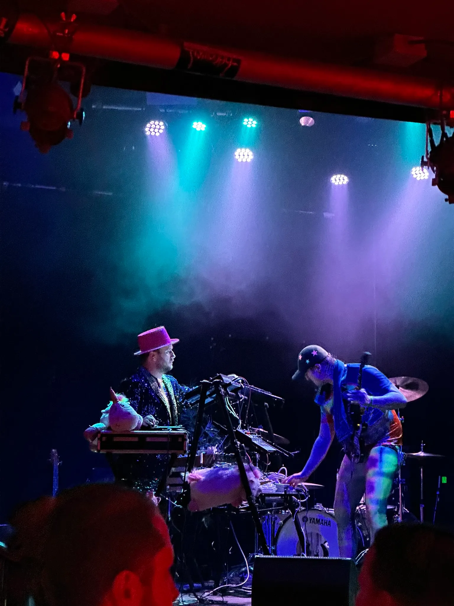 Wired Kimchi on a club stage in blue and pink light