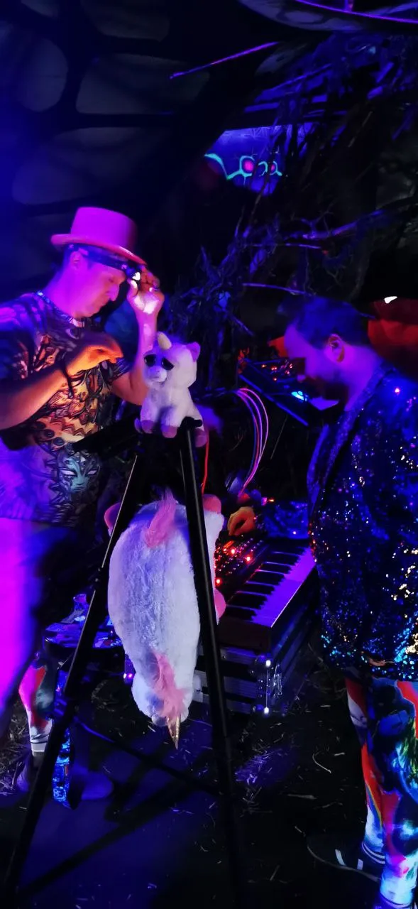 Neon-lit performer in a feathered costume